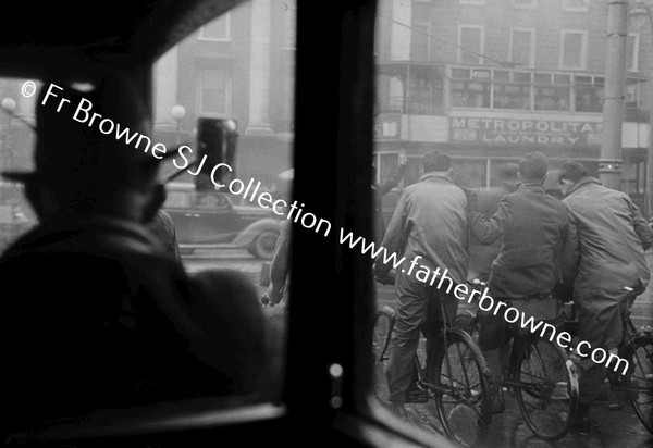 CYCLIST THROUGH BUS WINDOW